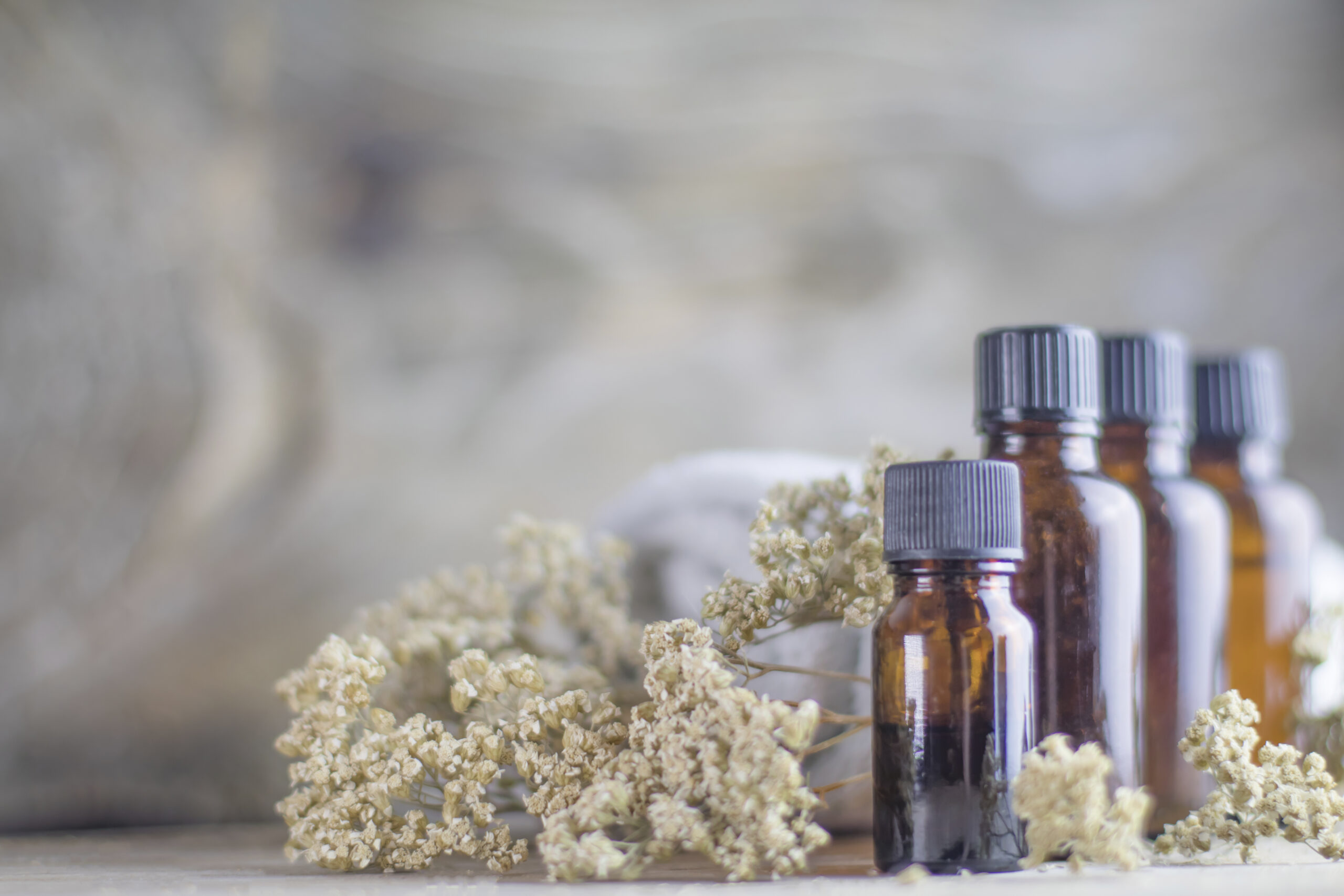 Bottles of essential oils and dried flowers